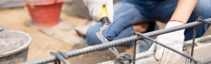bricklayer-worker-installing-brick-masonry-exterior-wall-with-trowel-putty-kni